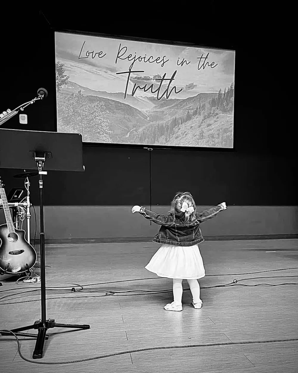 Little girl raising her hands in praise